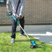 Makita DUR193Z line trimmer being used to cut medium length lawn
